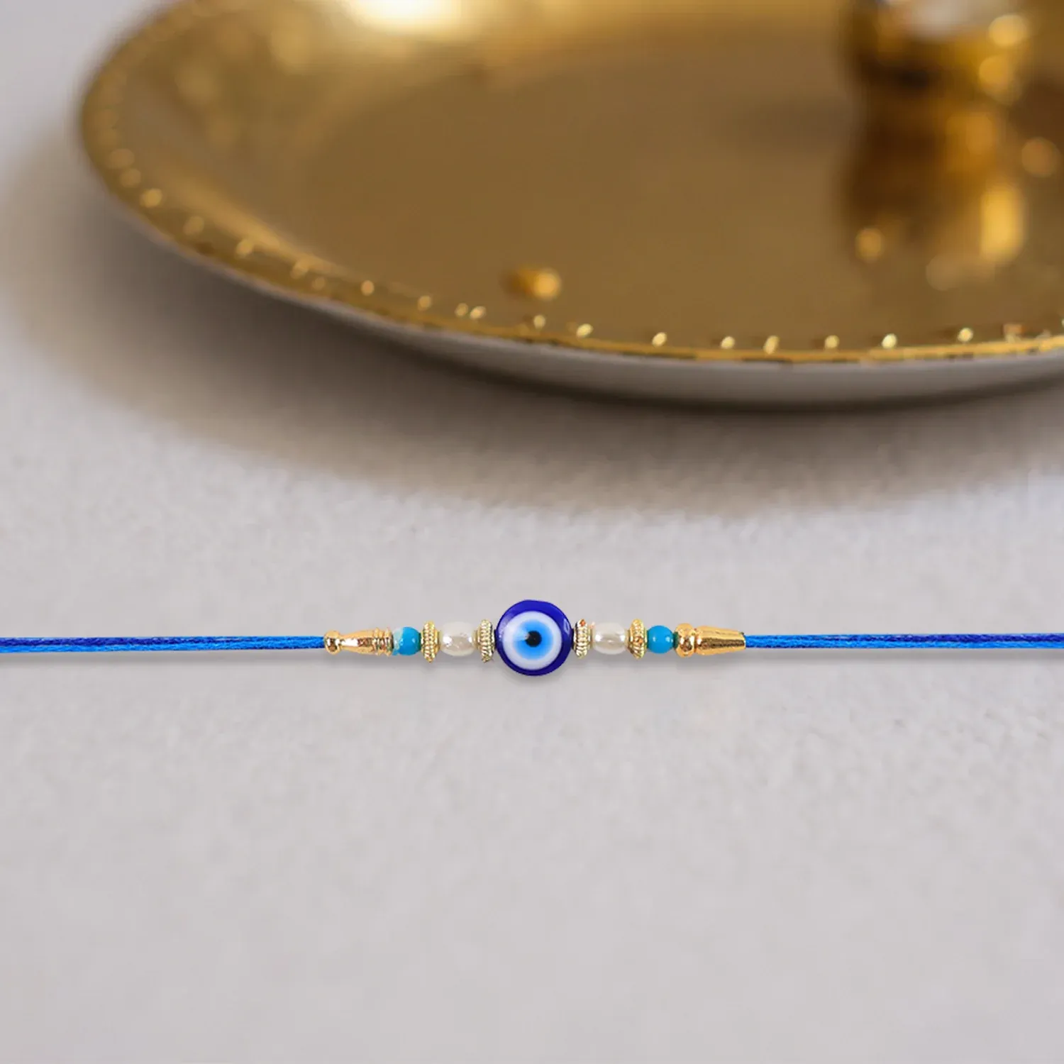 Blue Rakhi – Elegant Stone & Pearl Design for Brother - Detailed Feature View 1