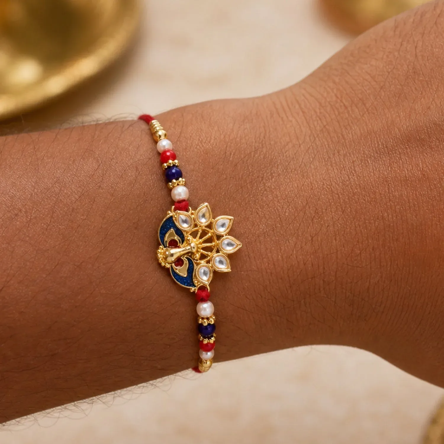 Peacock Rakhi – Elegant Pearl Beads & Bright Red Thread - Detailed Feature View 1