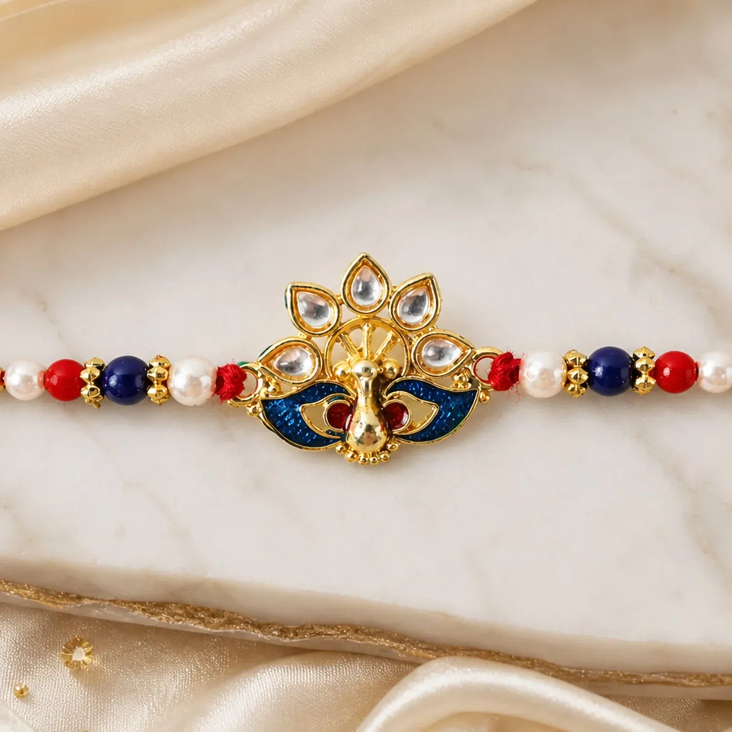 Peacock Rakhi – Elegant Pearl Beads & Bright Red Thread - Detailed Feature View 2