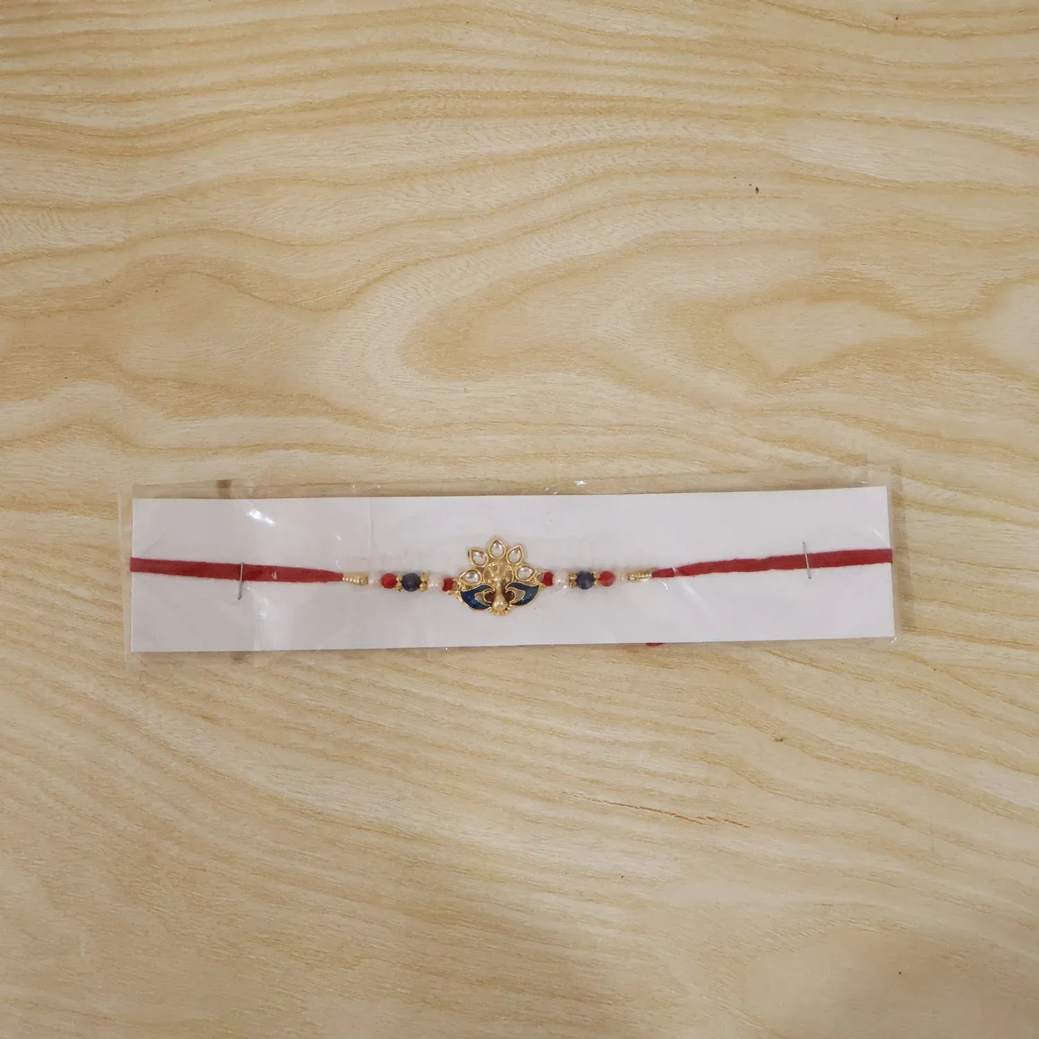 Peacock Rakhi – Elegant Pearl Beads & Bright Red Thread - Detailed Feature View 7
