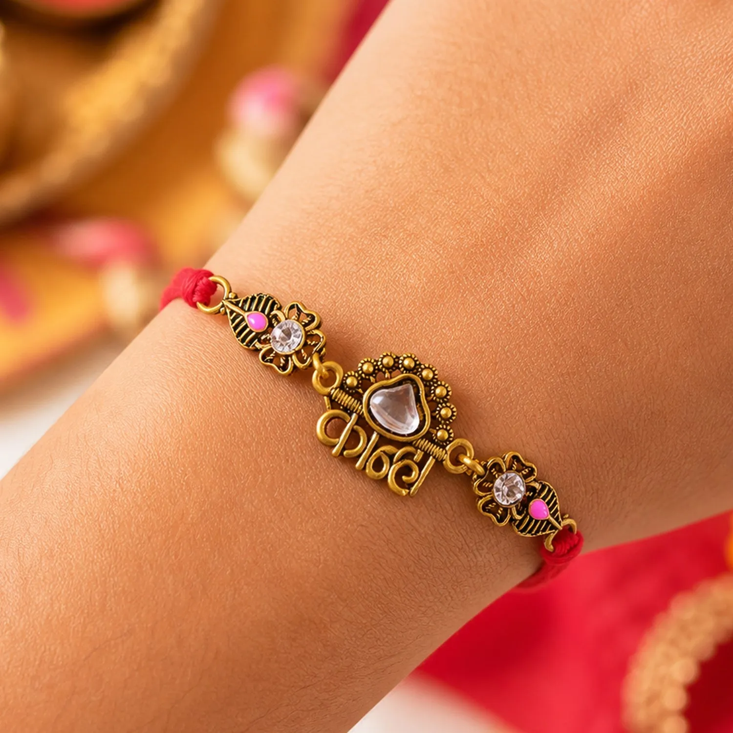 Antique Gold-Toned Kanha Rakhi with Kundan-Style Stone, Crystal Accents & Red Thread - Detailed Feature View 1