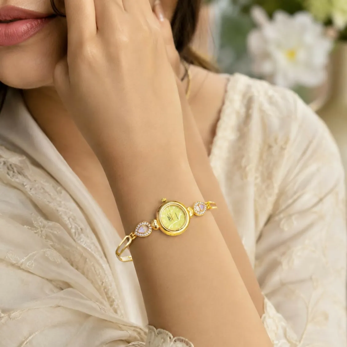 Elegant Gold-Tone Bracelet Watch with Pastel Yellow Dial and Purple Heart Accents - Detailed Feature View 1