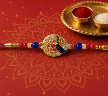 Striking Jewel-Studded Peacock Rakhi Paired with Blue-Red Beads and Tiny Pearls