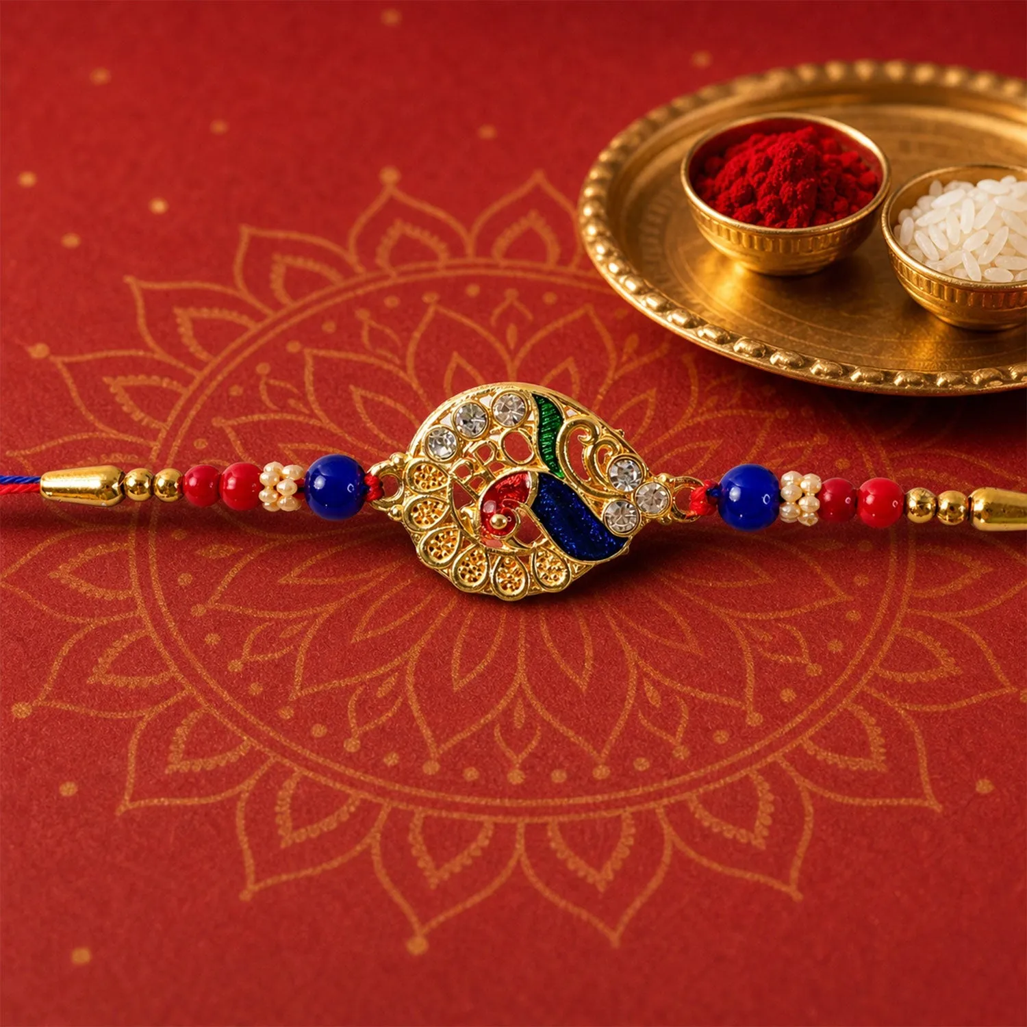 Premium Striking Jewel-Studded Peacock Rakhi Paired with Blue-Red Beads and Tiny Pearls - Buy Online at Alikart