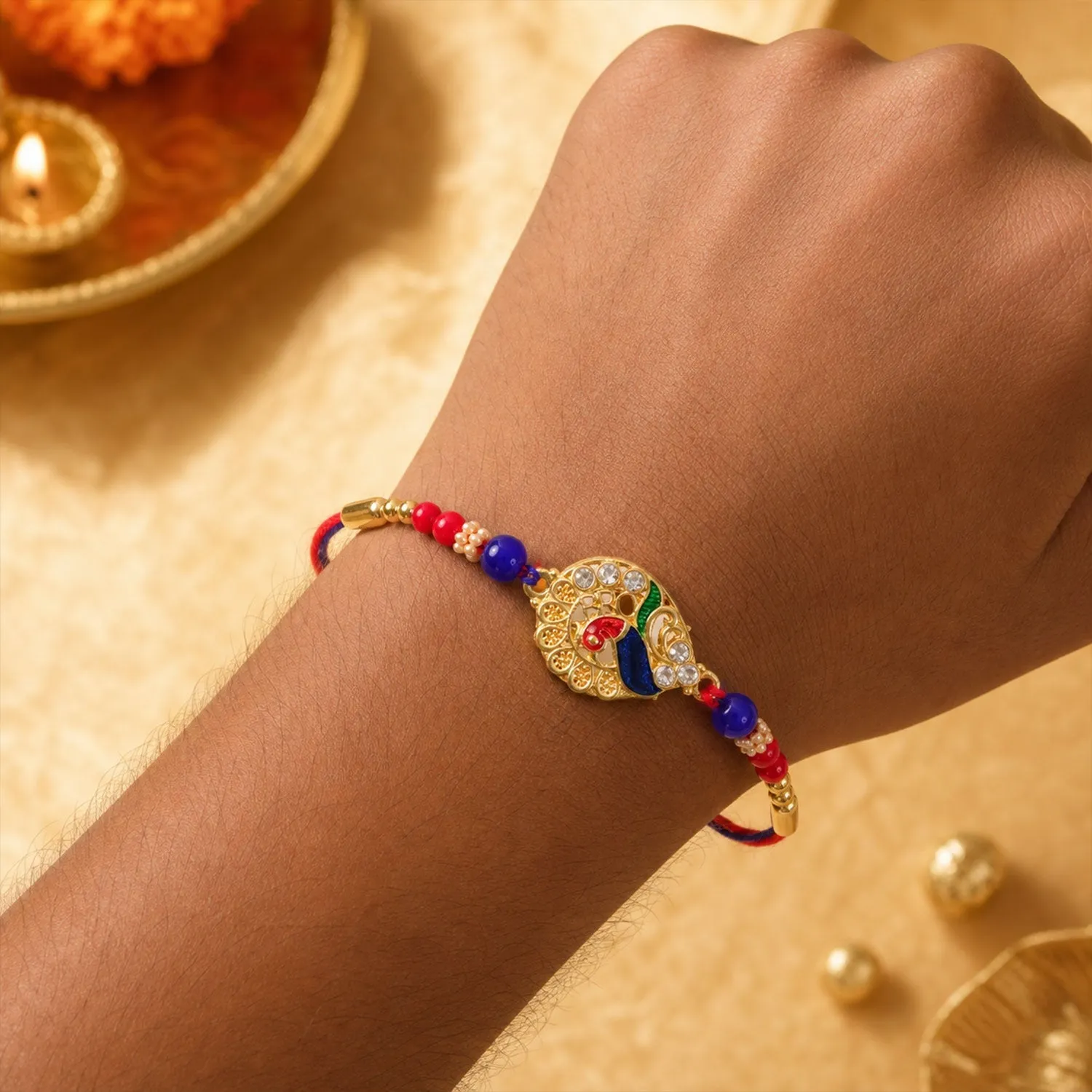Striking Jewel-Studded Peacock Rakhi Paired with Blue-Red Beads and Tiny Pearls - Detailed Feature View 2