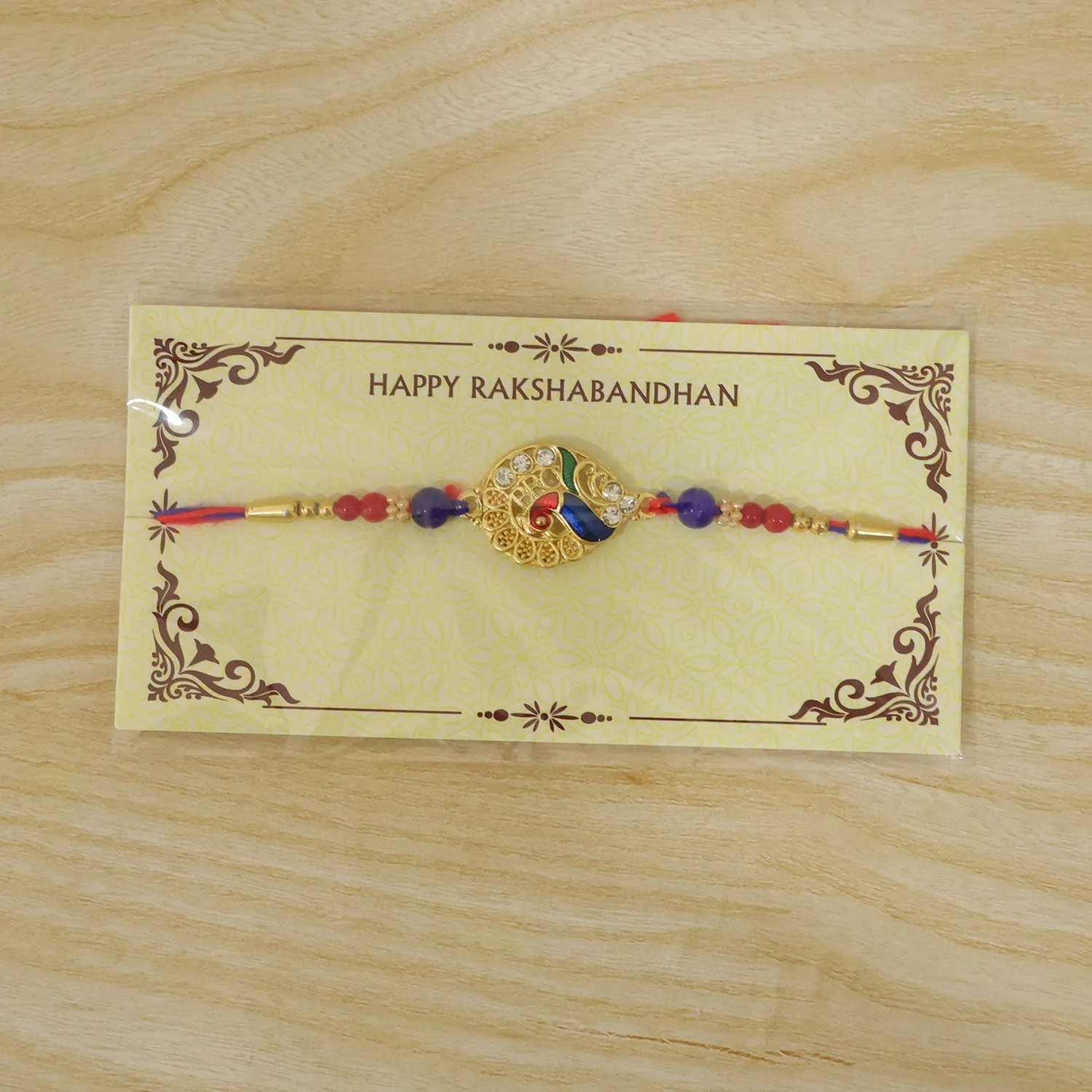 Striking Jewel-Studded Peacock Rakhi Paired with Blue-Red Beads and Tiny Pearls - Detailed Feature View 5