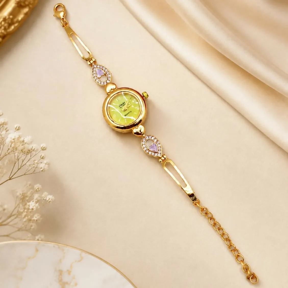 Elegant Gold-Tone Bracelet Watch with Pastel Yellow Dial and Purple Heart Accents - Detailed Feature View 3