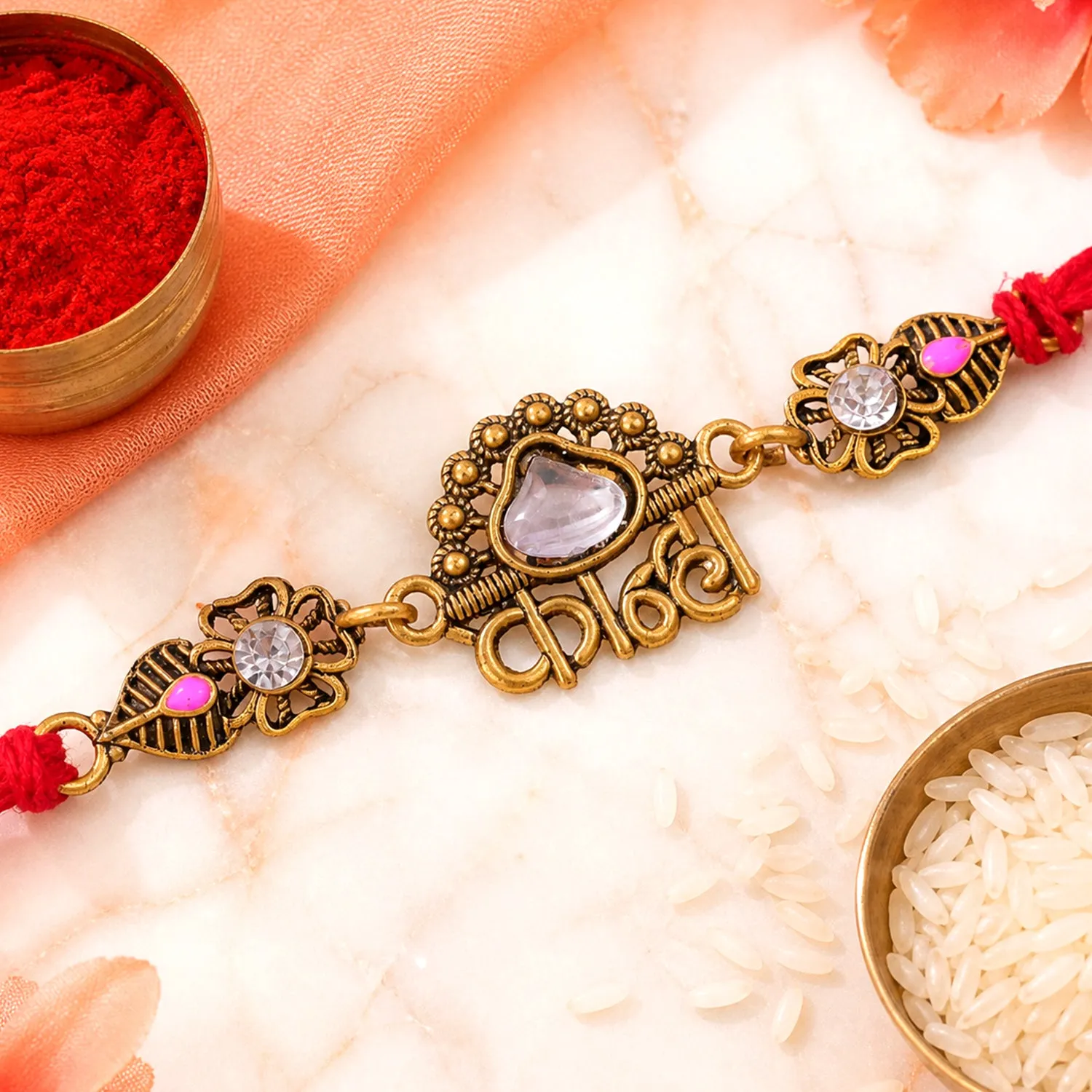 Antique Gold-Toned Kanha Rakhi with Kundan-Style Stone, Crystal Accents & Red Thread - Detailed Feature View 3