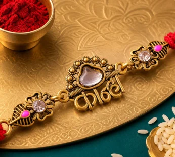 Antique Gold-Toned Kanha Rakhi with Kundan-Style Stone, Crystal Accents & Red Thread