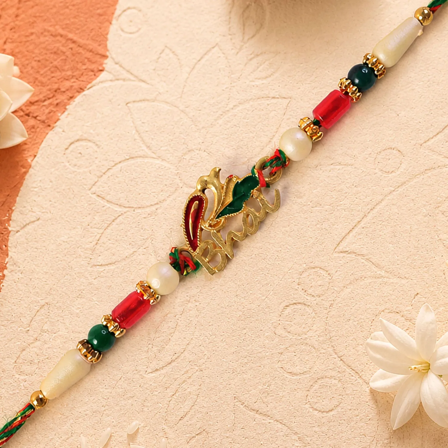 Premium Bold Rakhi showcasing Devanagari Script Charm, bead line and plaque look for Gift Use - Buy Online at Alikart