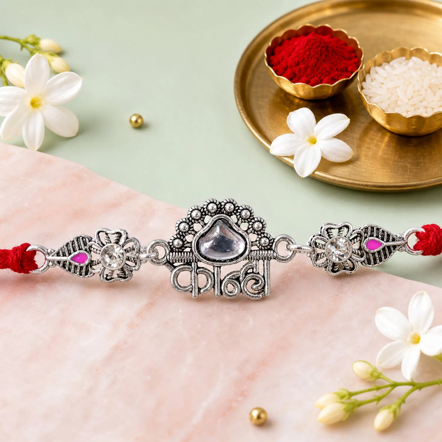 Premium Silver-Toned Kanha Rakhi with Kundan-Style Stone, Crystal Accents & Designer Red Thread - Buy Online at Alikart