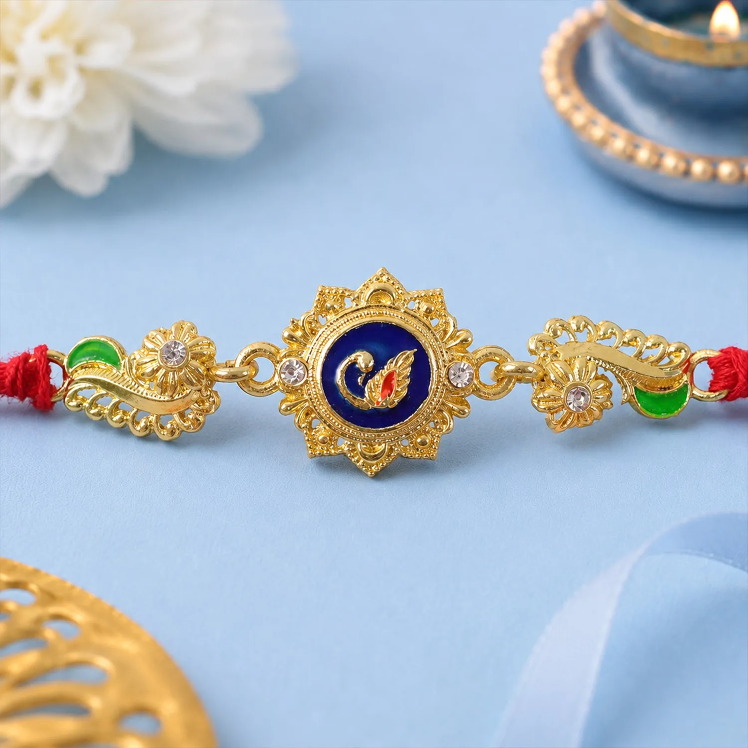 Premium Ornate Rakhi showcasing Blue Oval Medallion, metal trims and chain look for Gift Use - Buy Online at Alikart