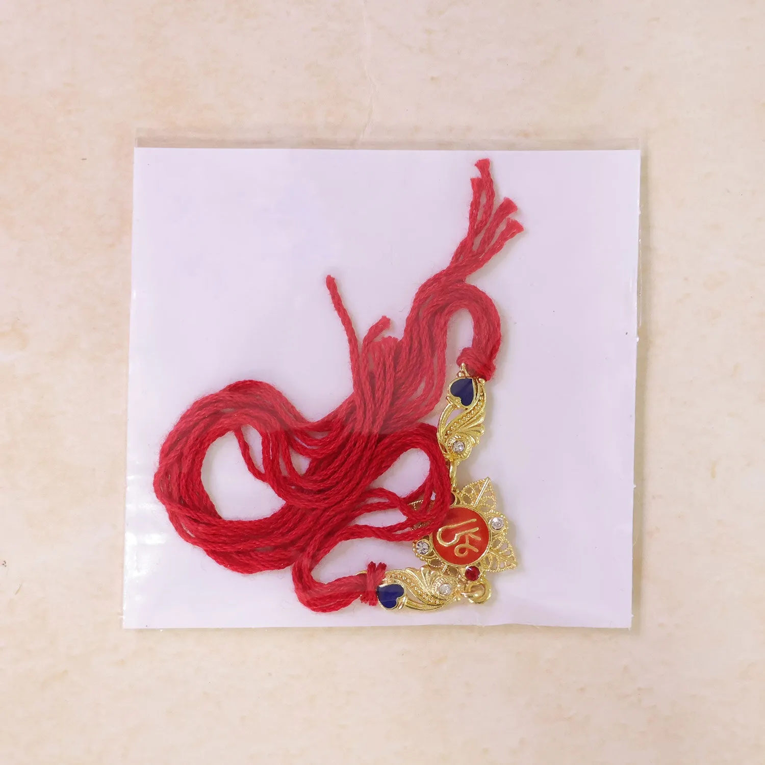 Festive Rakhi featuring Shri Plaque, leaf detail and thread style for Product Display - Detailed Feature View 4