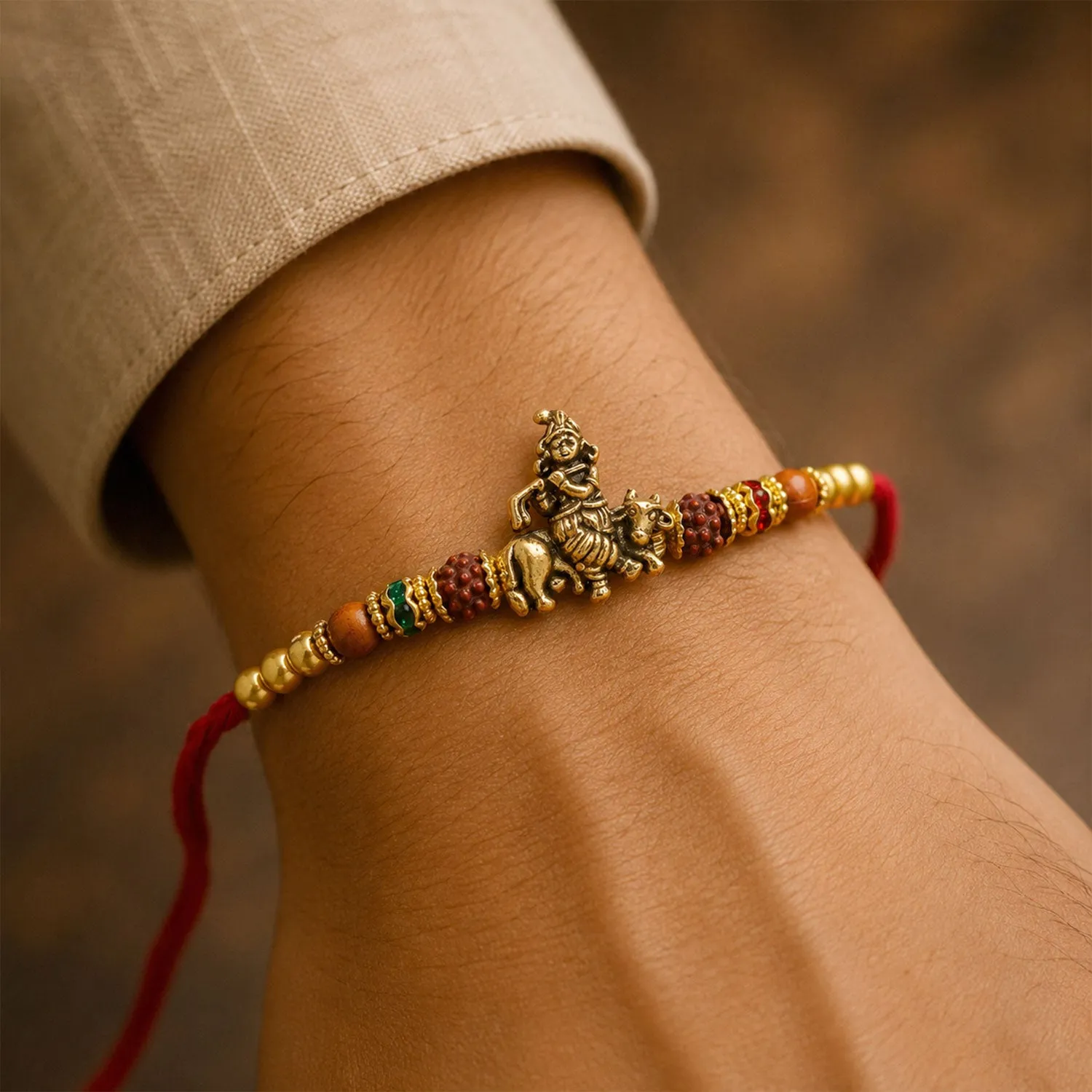 Bal Krishna Rakhi – Golden Idol Centre & Pearl Accents - Detailed Feature View 1
