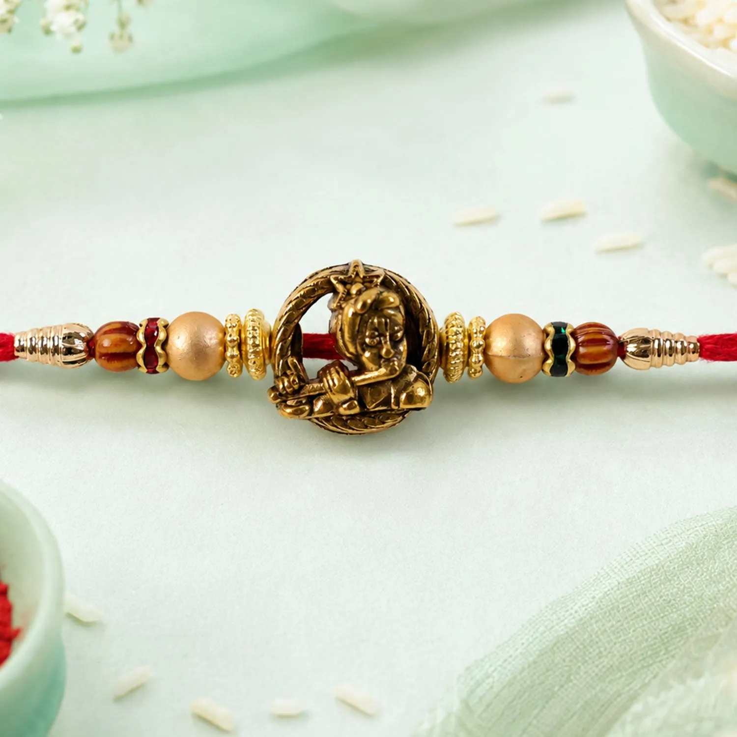 Premium Kanha Name Devotional Rakhi with Golden Flute and Red Thread - Buy Online at Alikart